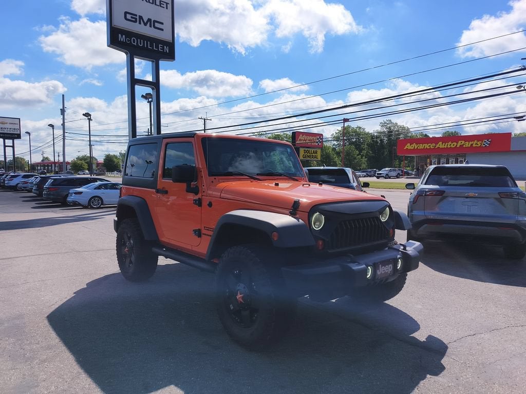 2012 Jeep Wrangler Sport in Orange — front three-quarter view